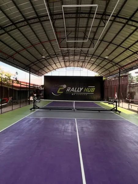 Net-level view of the empty RC Rally Hub pickleball court