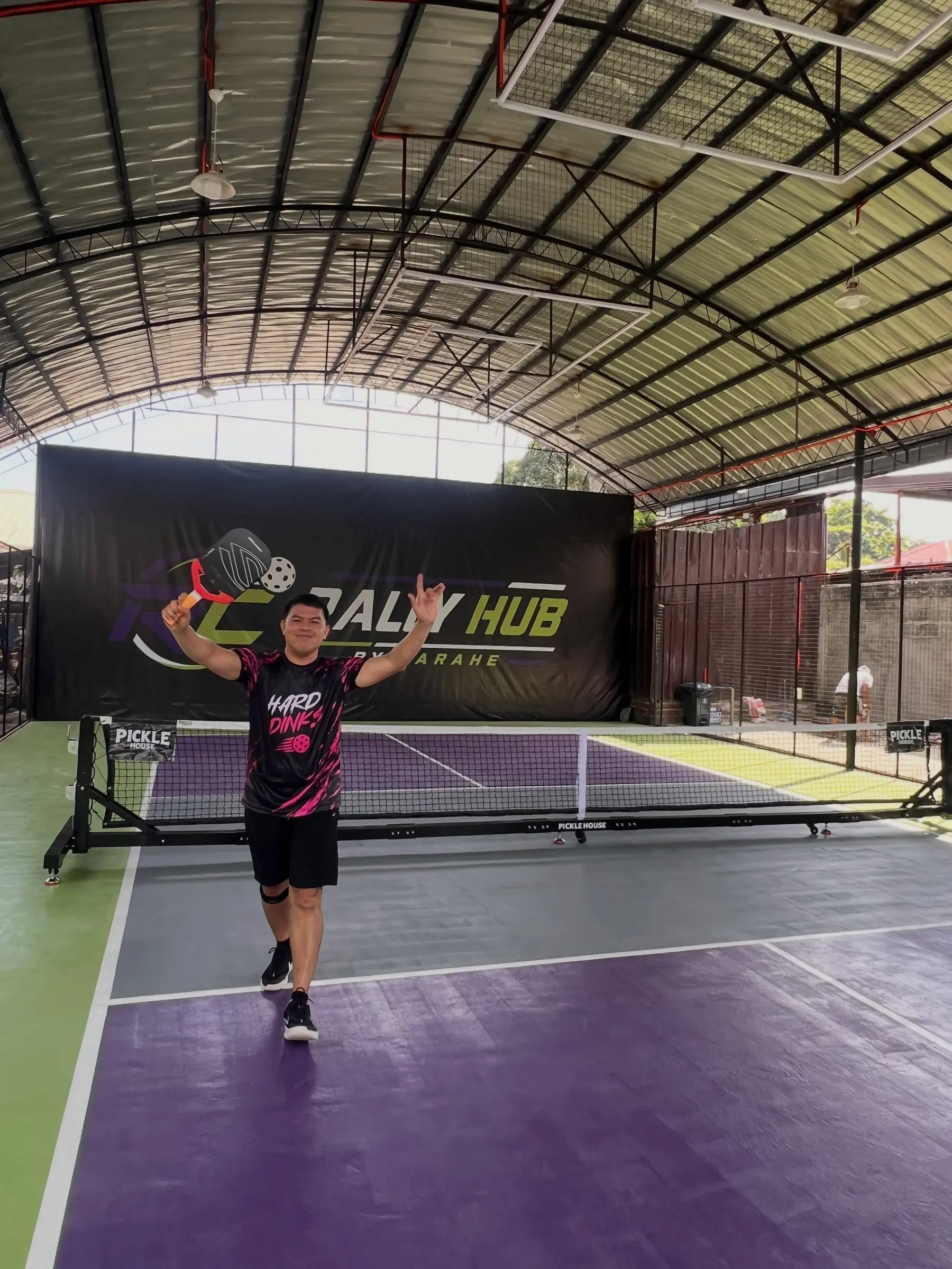 A player celebrating a point on the RC Rally Hub court